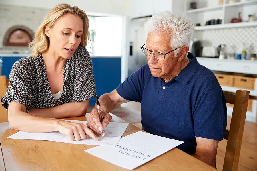 bigstock-Woman-Helping-Senior-Man-To-Co