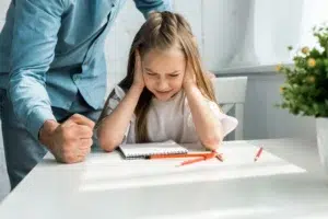 cropped-view-of-father-hitting-desk-with-fist-near