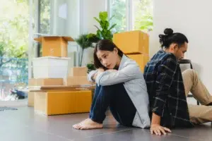 sad-asian-couple-packed-box-and-prepare-to-move-ho